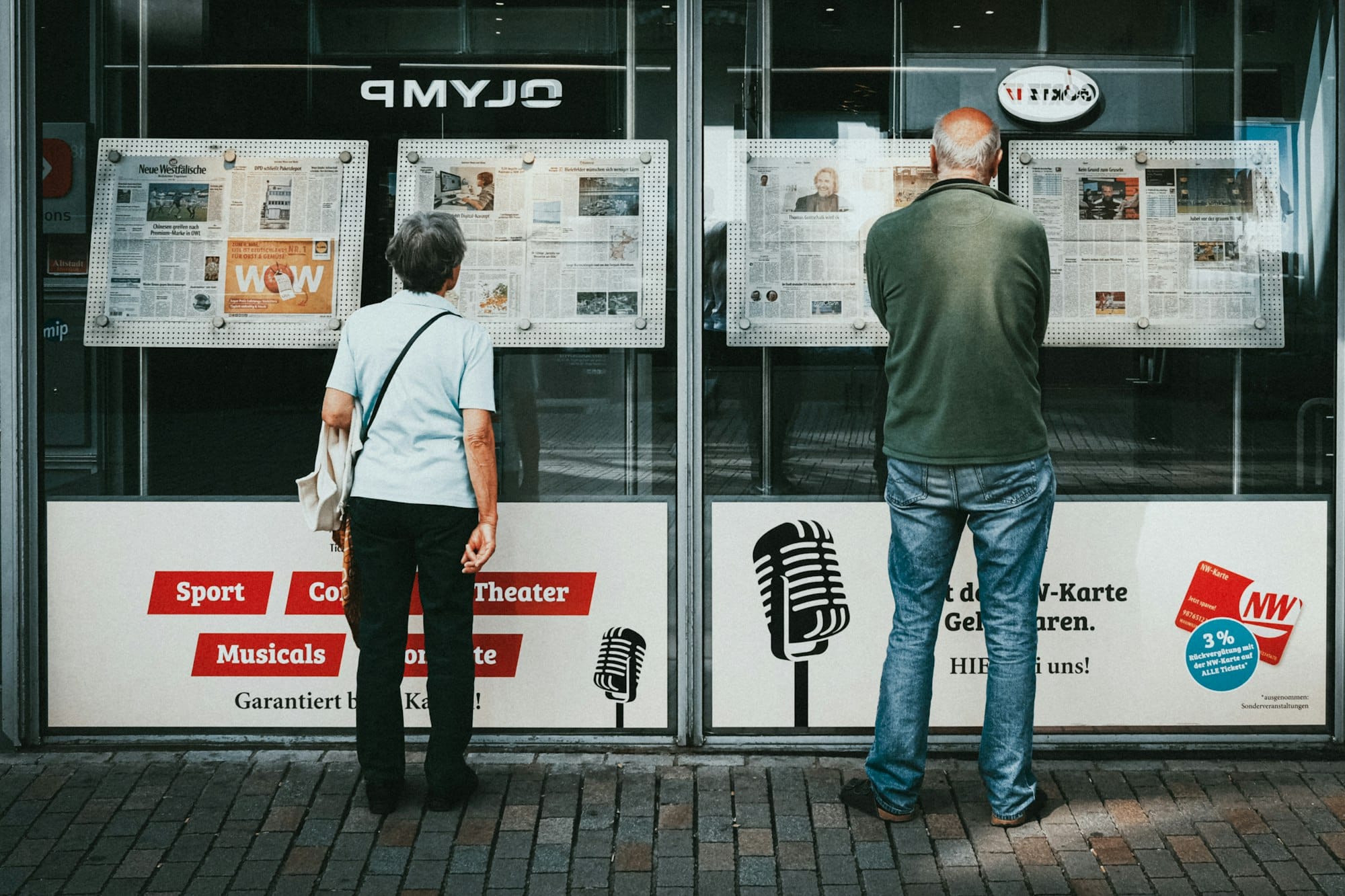 a couple of people standing outside of a building