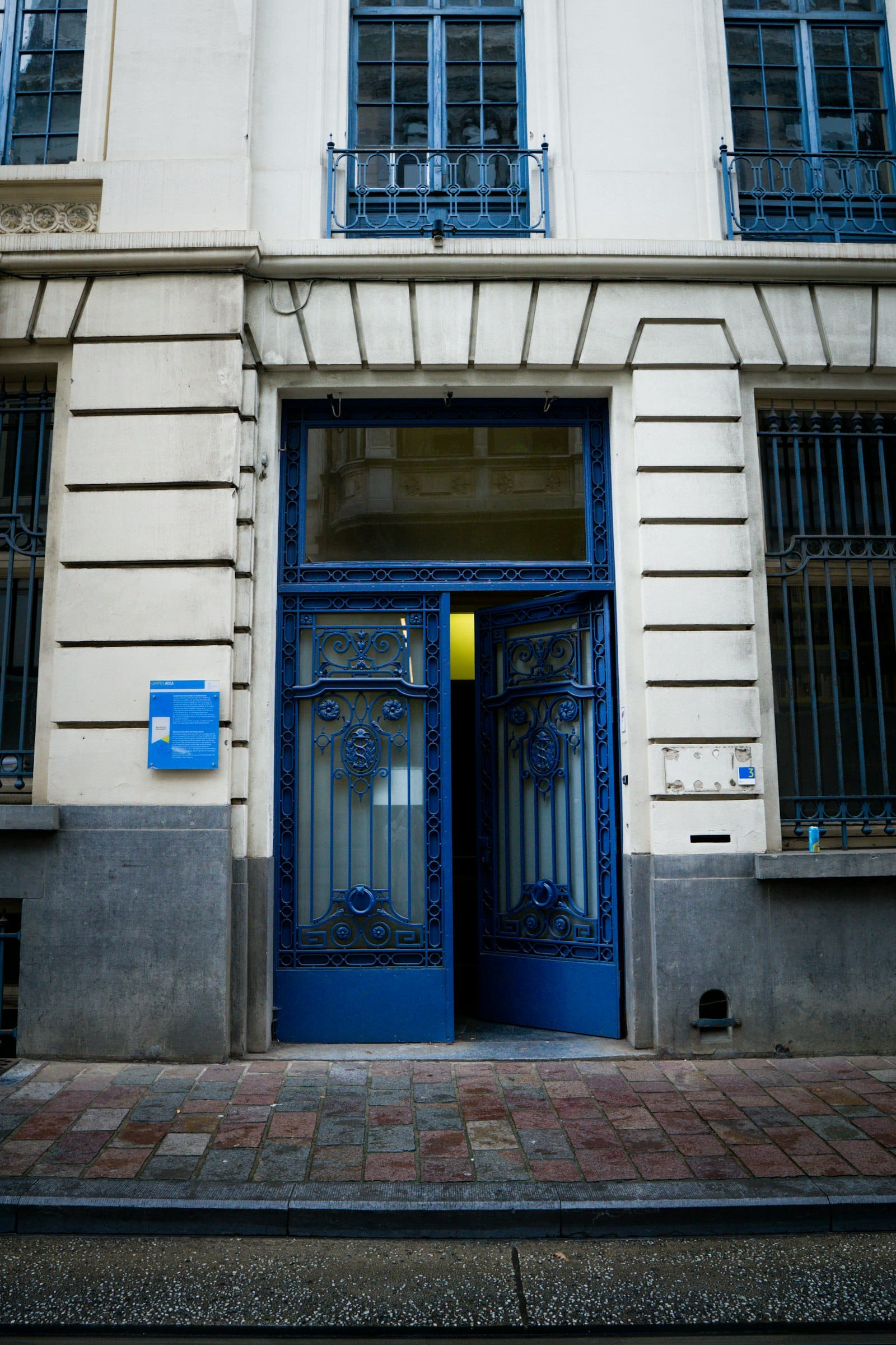 blue wooden door on white concrete building